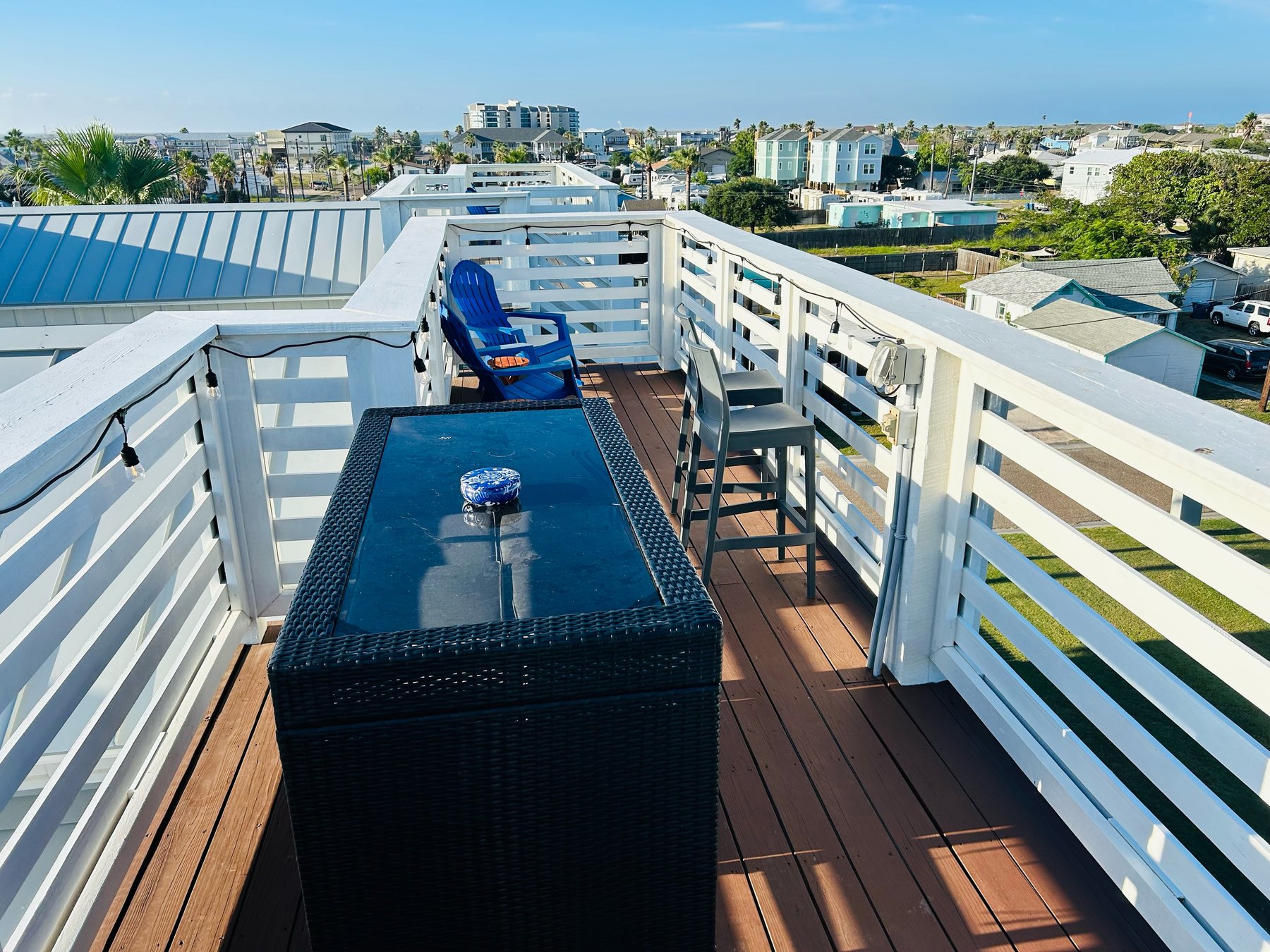 Crow’s Nest rooftop deck with string lights and island views
