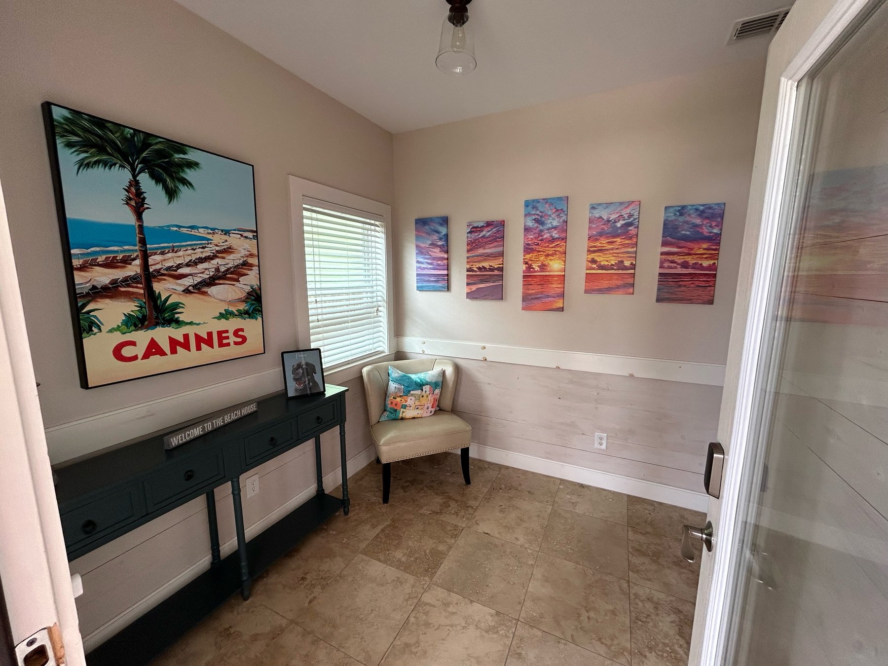 Entry area with Cannes art and sunset panels