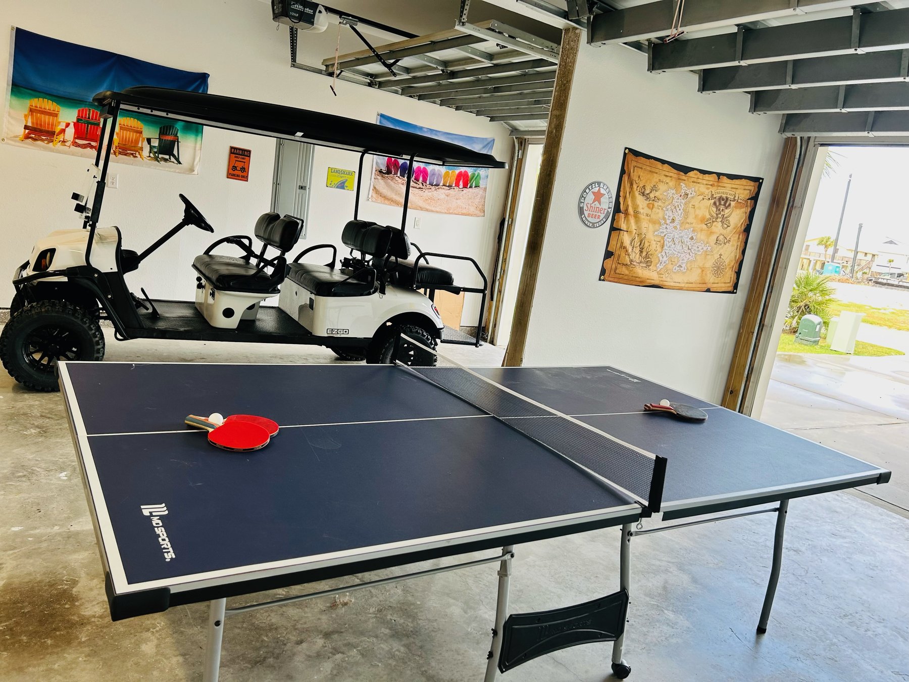 Golf cart and ping pong table in the garage