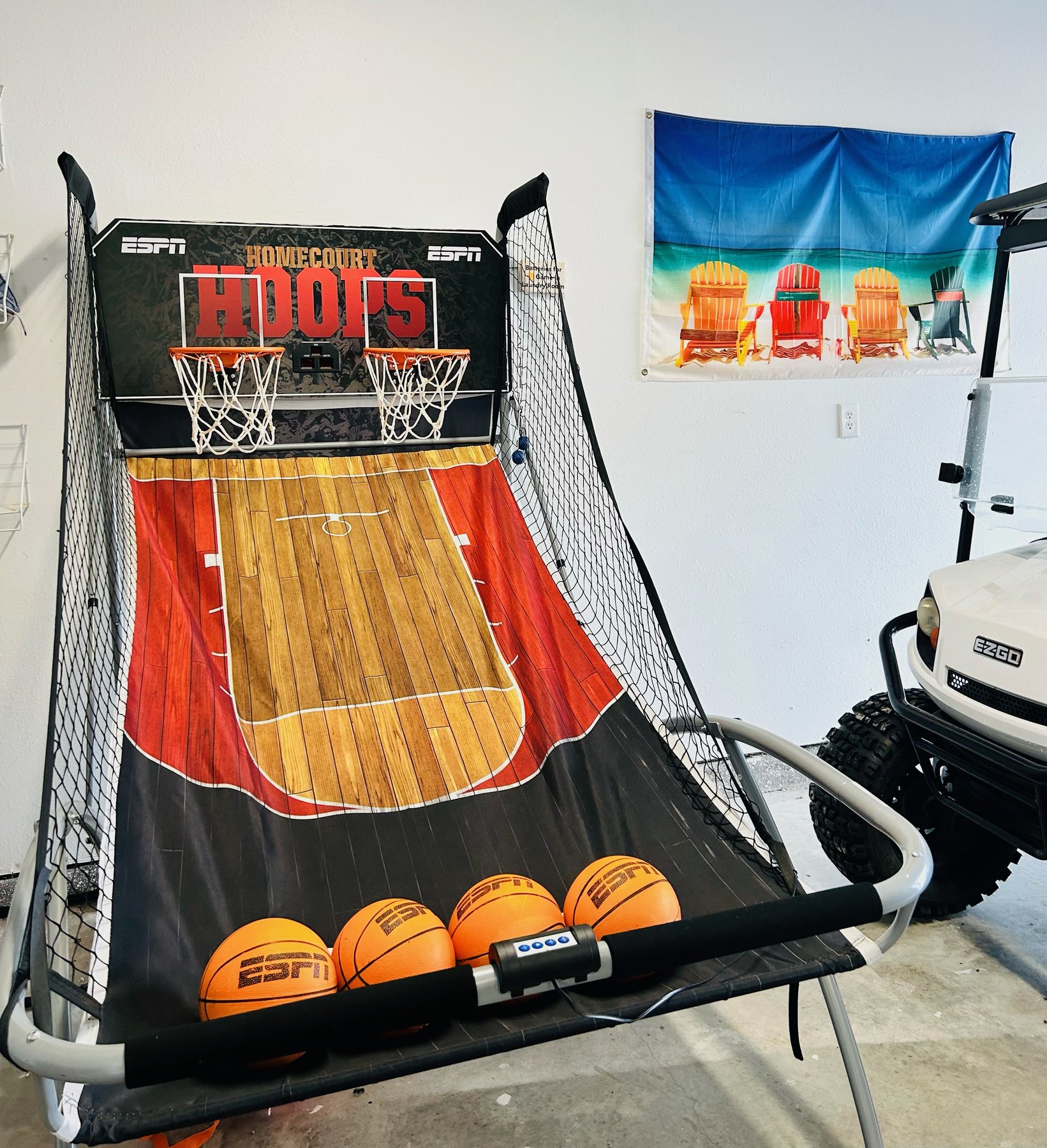 Basketball arcade and golf cart in the garage